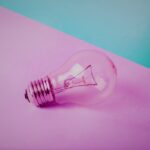 a clear lightbulb on a pink background