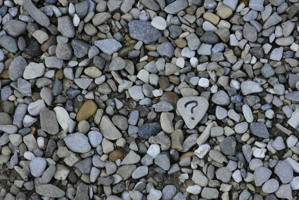 Collection of pebbles etched with a question mark