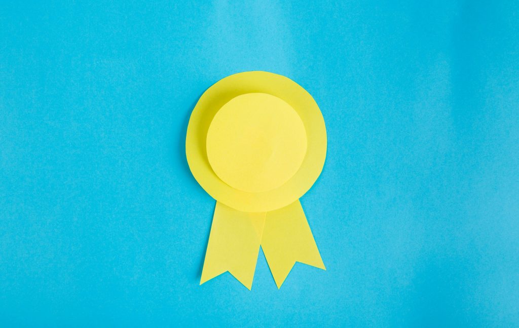 yellow award ribbon on a blue background