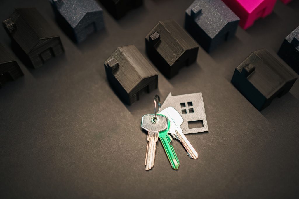 A birds eye view of a set of keys amongst small models of houses