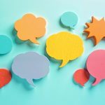 Scattered Post It notes in the shape of speech bubbles