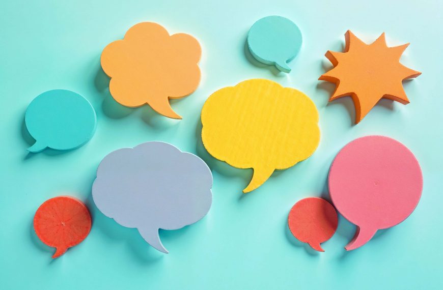 Scattered Post It notes in the shape of speech bubbles